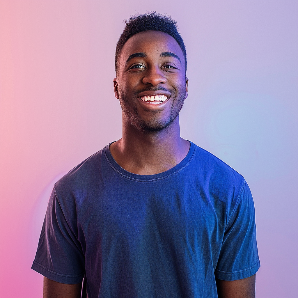 A photo of an attractive young black man with short hair, smiling at the camera, wearing a dark blue t-shirt. He is standing in front of a gradient background that transitions from light purple to pink. The lighting should be soft and even, highlighting his features without harsh shadows or reflections. His expression radiates confidence and warmth, adding depth to the overall composition. --ar 128:109