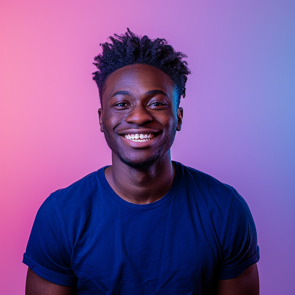 A photo of an attractive young black man with short hair, smiling at the camera, wearing a dark blue t-shirt. He is standing in front of a gradient background that transitions from light purple to pink. The lighting should be soft and even, highlighting his features without harsh shadows or reflections. His expression radiates confidence and warmth, adding depth to the overall composition. --ar 128:109